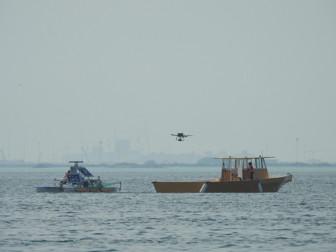 A drone retrieving an object using SPIBOT in a maritime environment